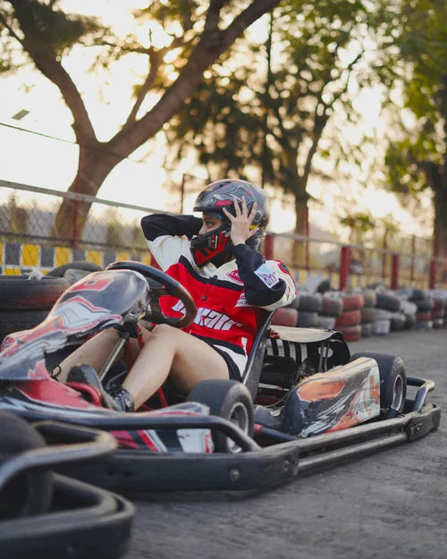 Person in a go-kart with a helmet on a track